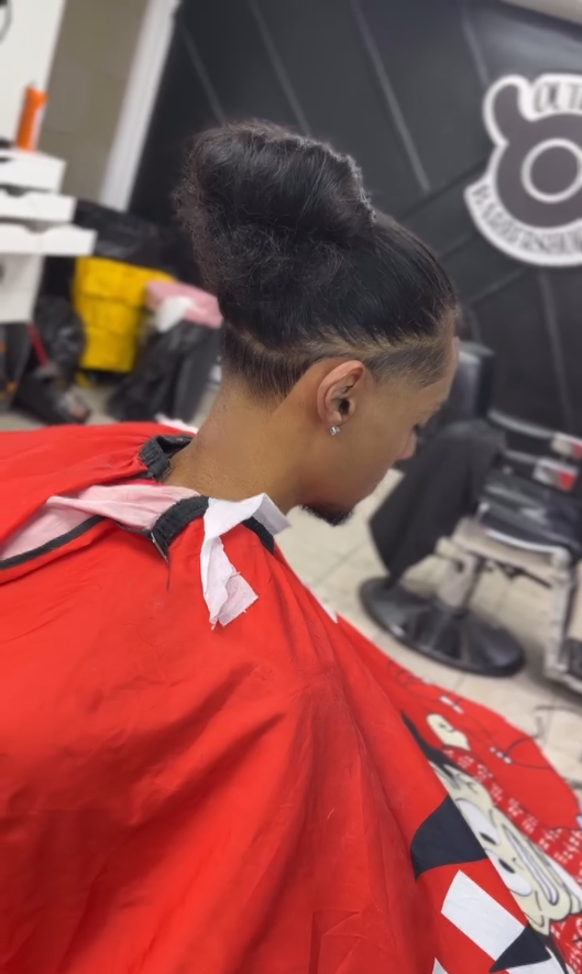 Client with hair tied in a bun and a crisp tapered neckline